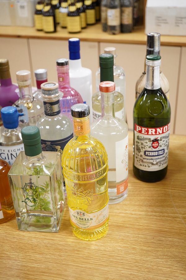 A large collection of various spirits and liqueurs, mostly gin, twenty six bottles